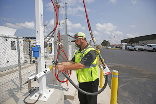 Lee Pearson, route manager for Waste Management's Roll-Off dumpsters demonstrates a CNG fast-fill at their facility on W Reno in Oklahoma City, Tuesday August 8, 2017. Photo By Steve Gooch, The Oklahoman